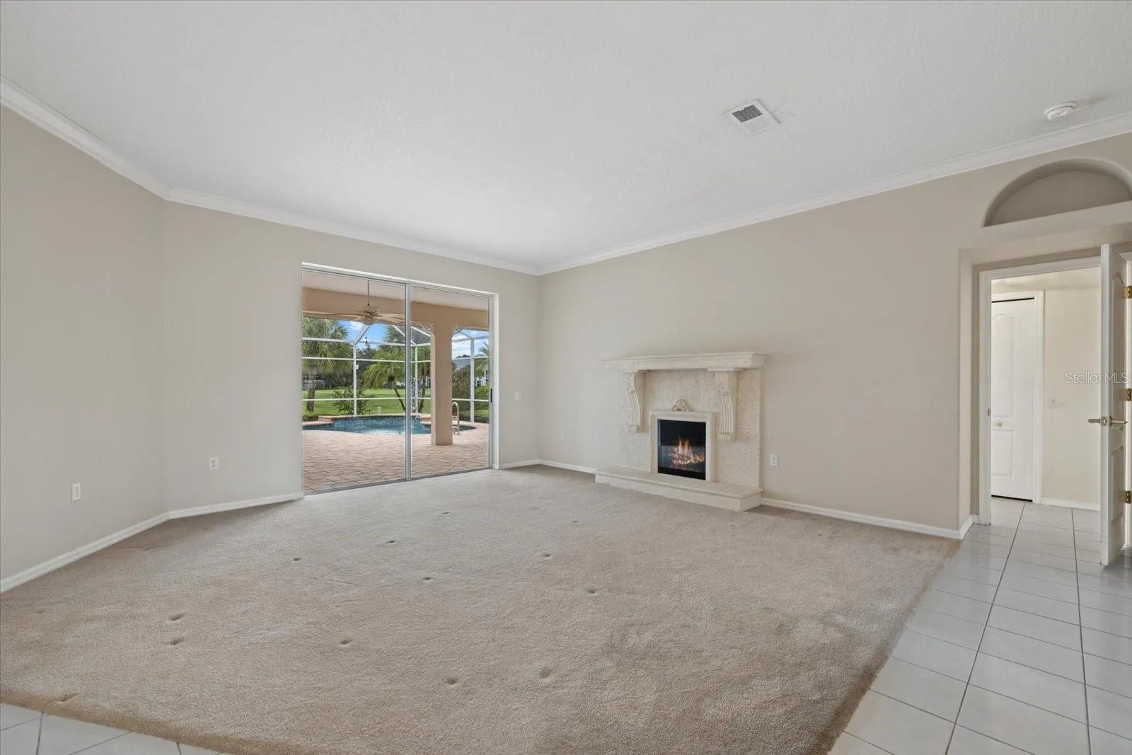Living Room with Sliders to the Lanai &amp; Pool.