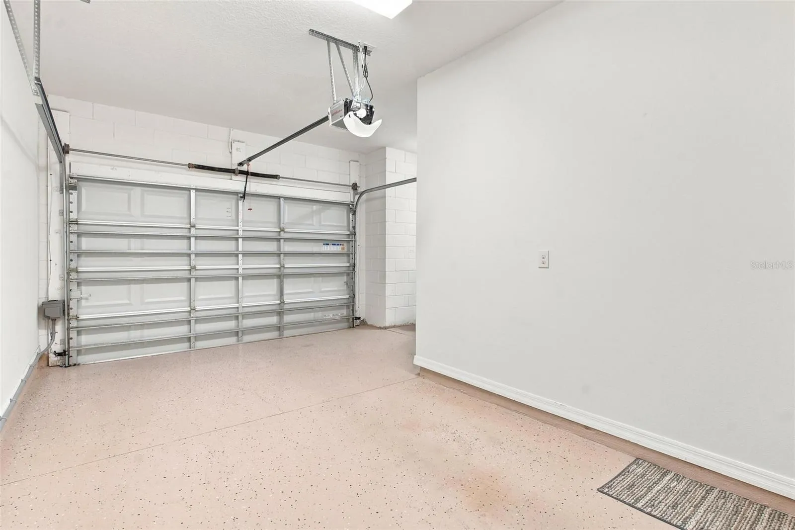 Extended 1 car garage features built in storage and room for golf cart.