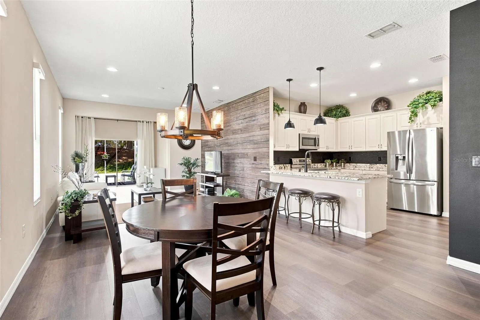 Dining Area-Open Living Spaces greet you as you enter the home. Luxury Vinyl Flooring thru main living area. Kitchen overlooks dining, living, and bonus area.