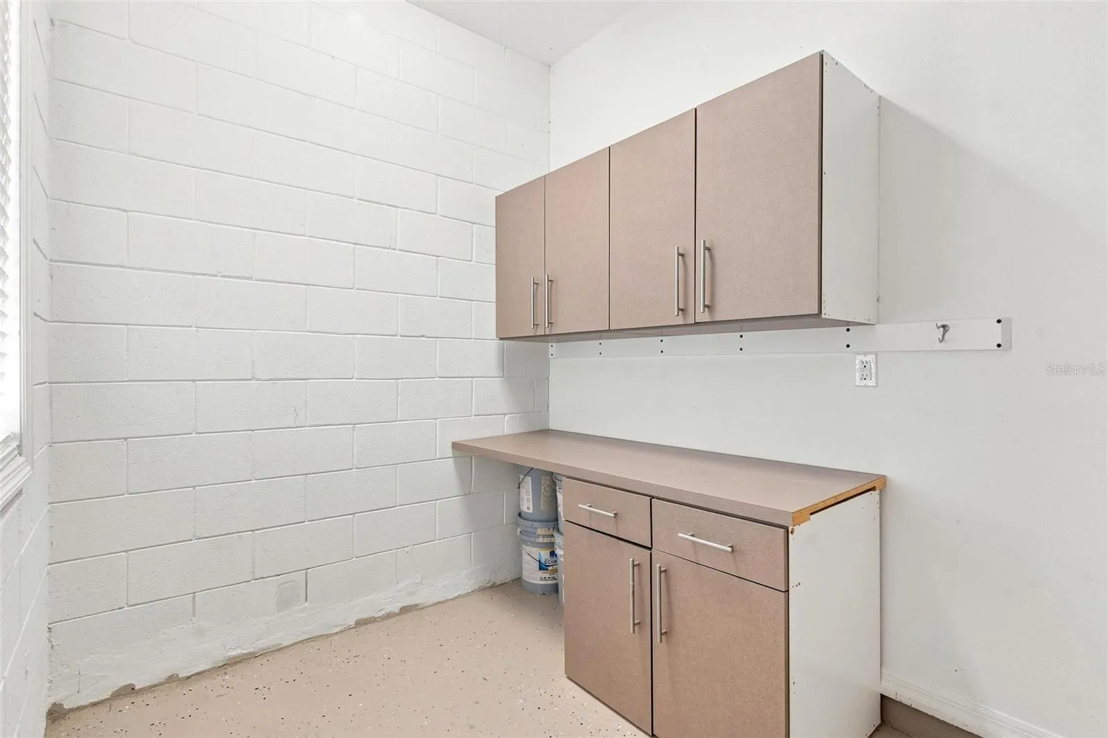 Extended 1 car garage features built in storage and room for golf cart.