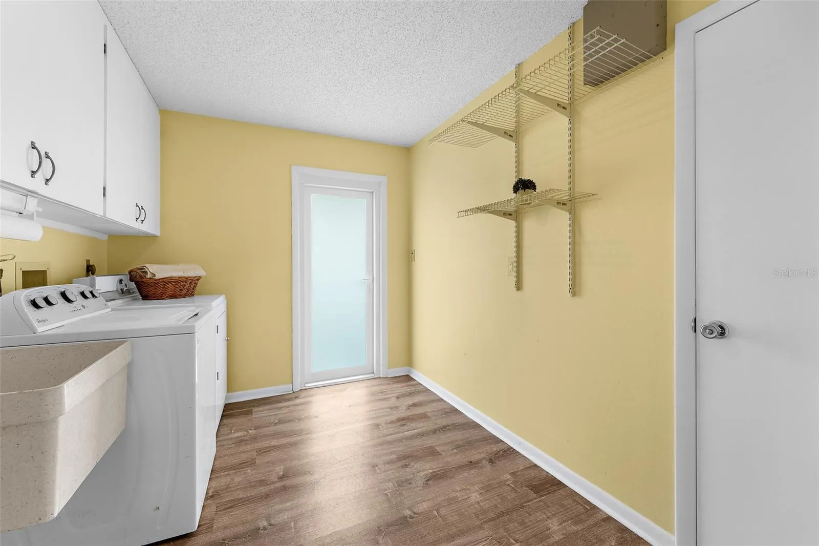 Separate utility room with access to garage and separate door to the side of the home.