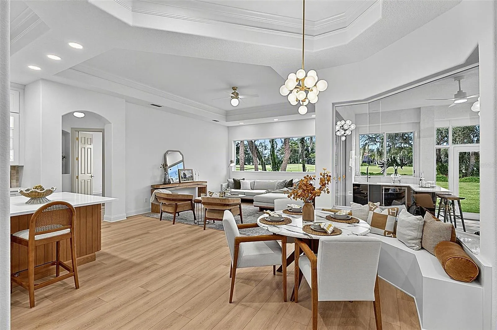 Spectacular Kitchen, cozy breakfast nook with bench setting, seamless window looking out to soliarium and family room with wall of windows for an execlant view of backyard and golf course