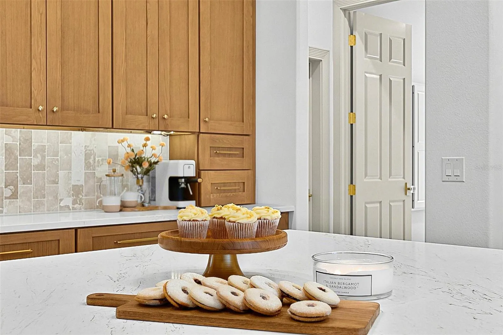 Kitchen Island Centerpiece with wall of custom wood cabinets