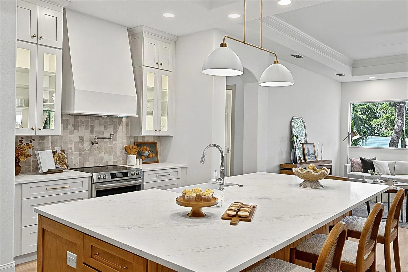 Elegant Centerpiece Kitchen Island with crafted wall of tile and lighted window cabinets