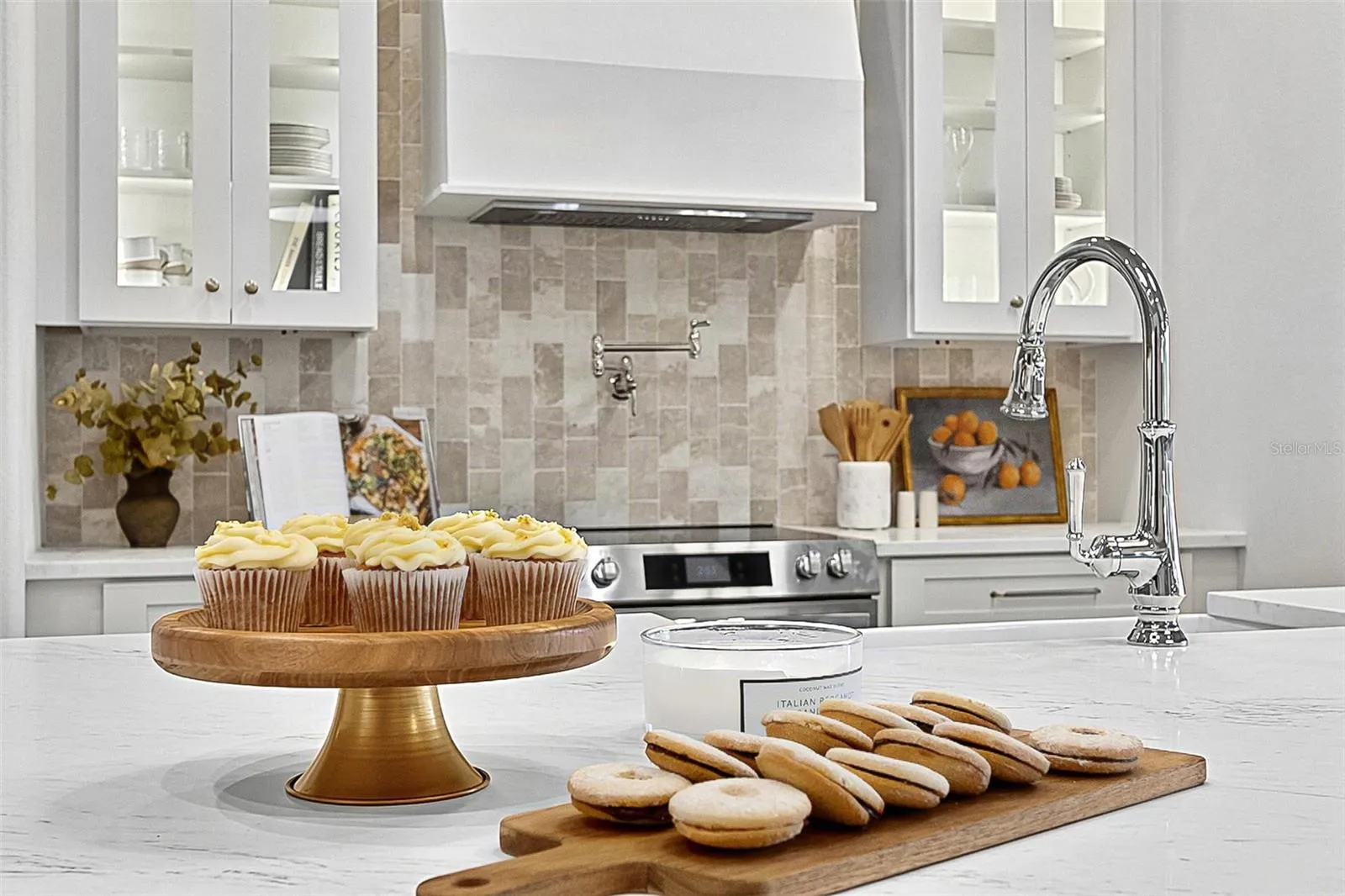 Elegant Centerpiece Kitchen Island with crafted wall of tile and lighted window cabinets