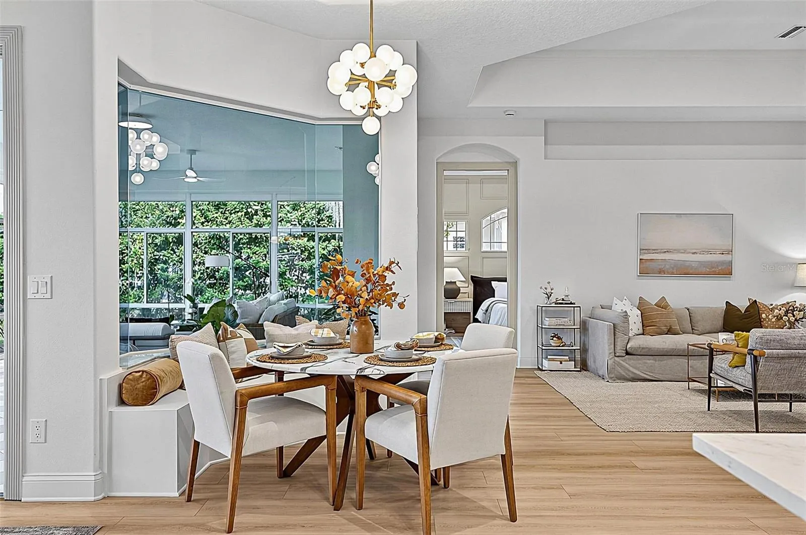 Beautiful Breakfast nook with custom window seating looking our to solarium and righ off formal living room