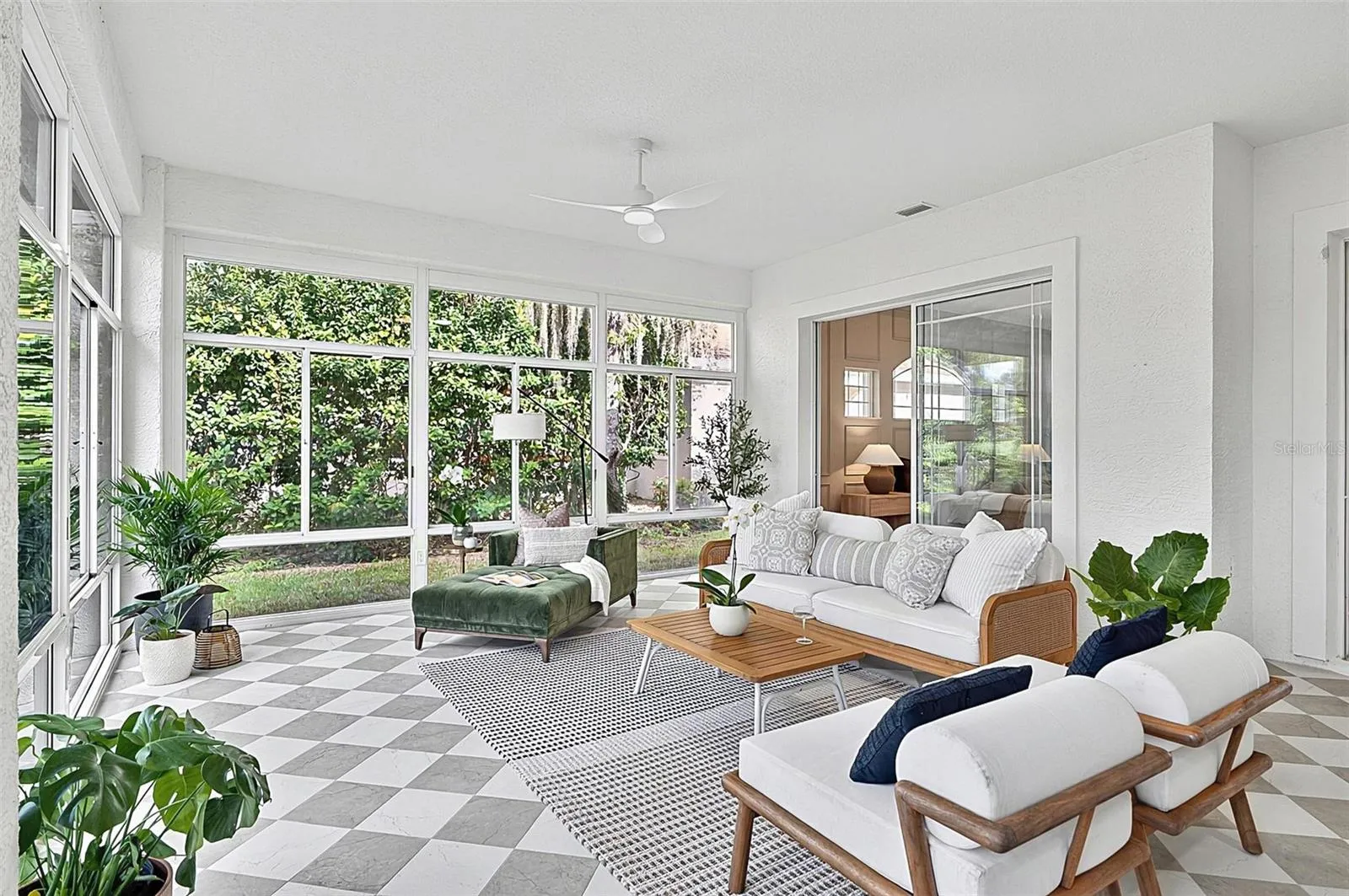 Peaceful Solarium with wall to wall enclosed screened windows looking out on to backyard and golf course. Room is aired