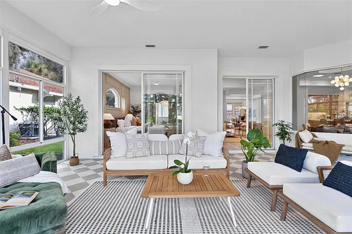 Peaceful Solarium with wall to wall enclosed screened windows looking out on to backyard and golf course. Room is aired