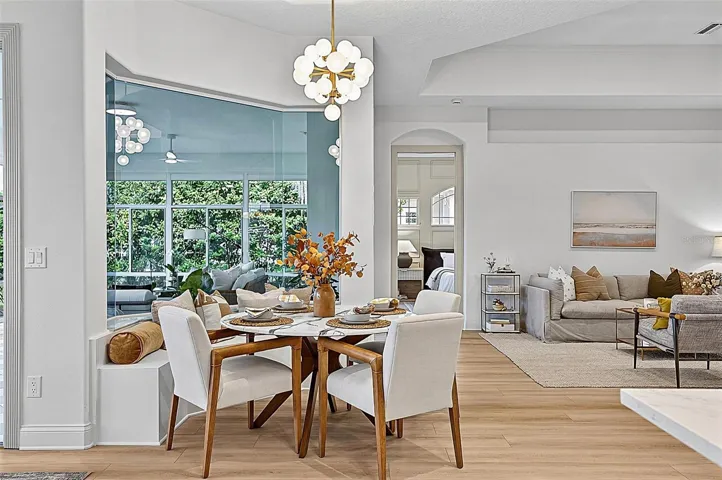 Beautiful Breakfast nook with custom window seating looking our to solarium and righ off formal living room