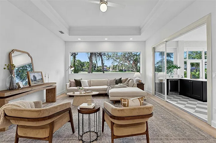 Family room with Stunning views through wall of window looking out to backyard and golf course with triple sliders onto the solarium