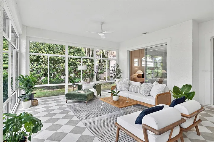 Peaceful Solarium with wall to wall enclosed screened windows looking out on to backyard and golf course. Room is aired