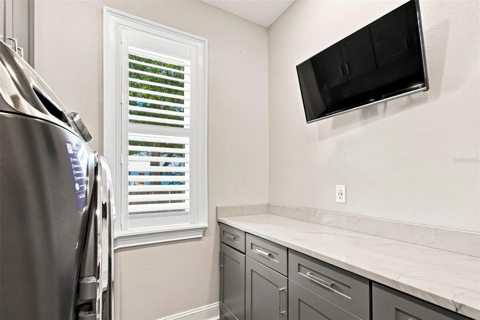 LAUNDRY ROOM WITH TV FOR YOUR FOLDING PLEASURE
