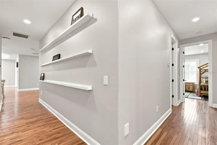 HALLWAY WITH ATTACHED SHELVING FOR PICTURES