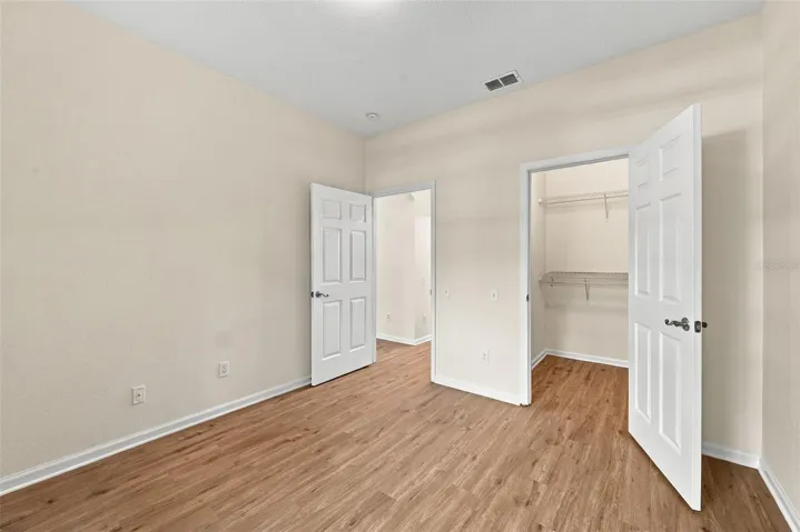 2nd bedroom- view of walking in closet