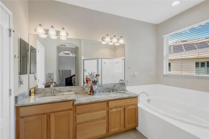 Double sink, garden tub, private water closet and shower in Primary Bathroom