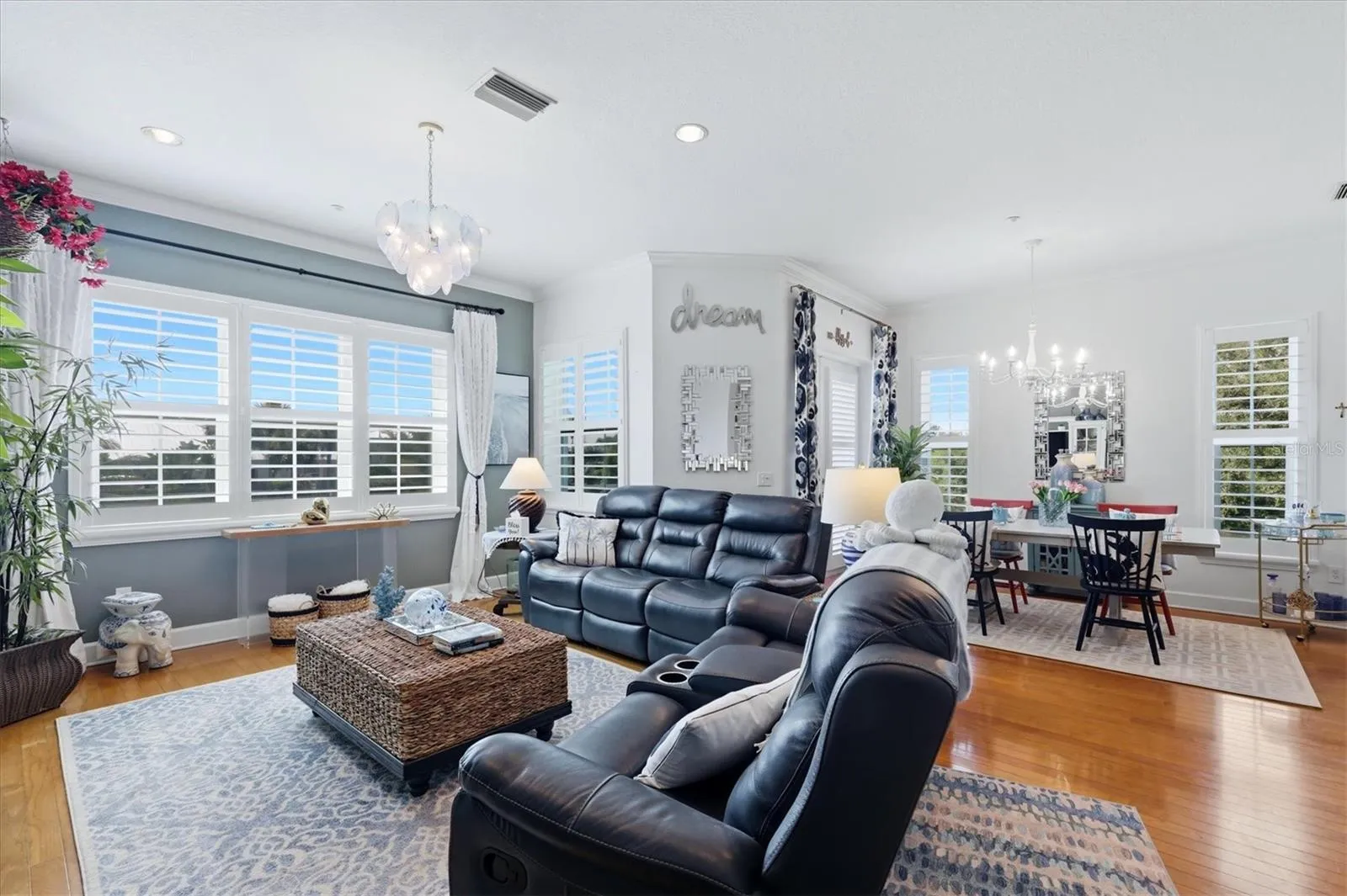 Living &amp; Dining areas accented with plantation shutters on the brand new impact-resistant windows &amp; doors