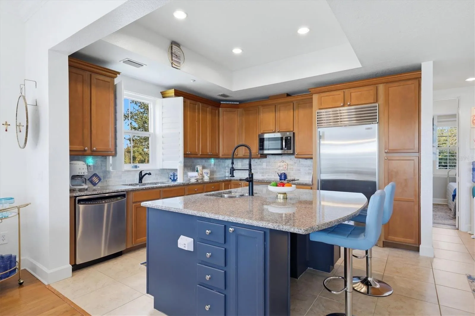 Kitchen features Sub-zero refrigerator and stainless appliances
