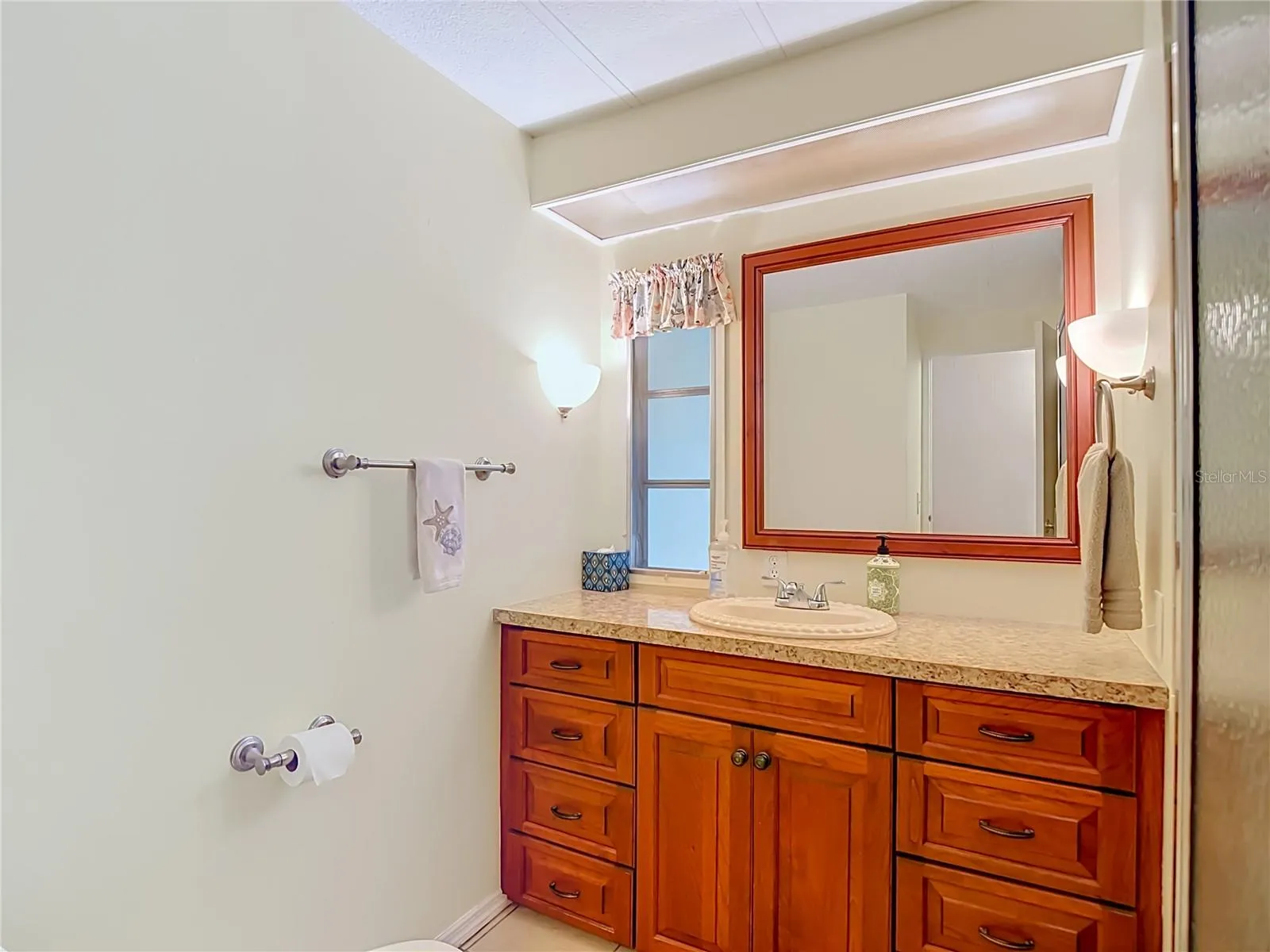 Secondary Bath with updated cabinetry and natural lighting.