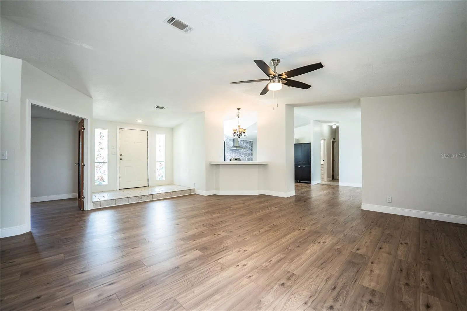 Living Room looking at entrance, kitchen and bonus bedroom