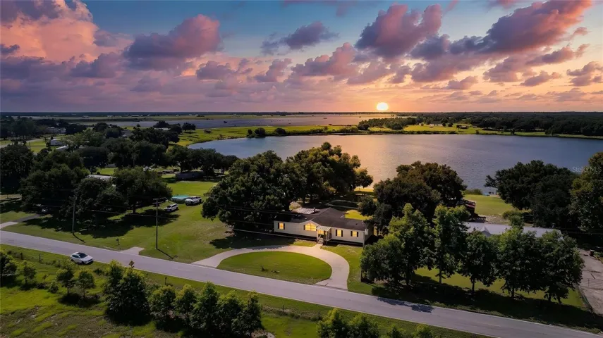 Front of house with view of Lake Walker - twilight