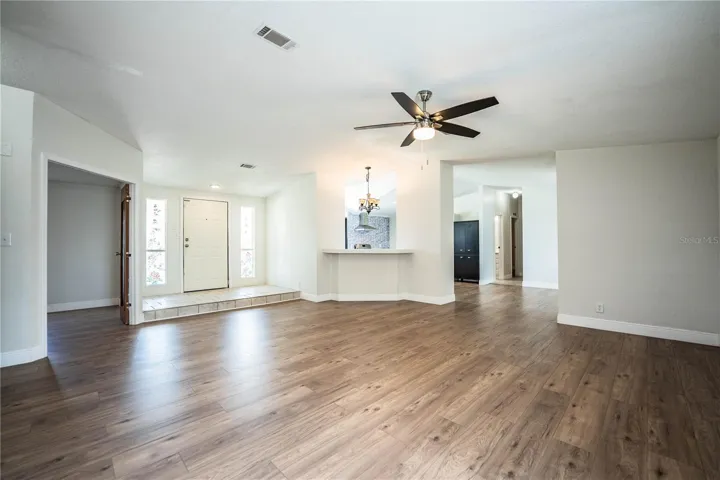 Living Room looking at entrance, kitchen and bonus bedroom