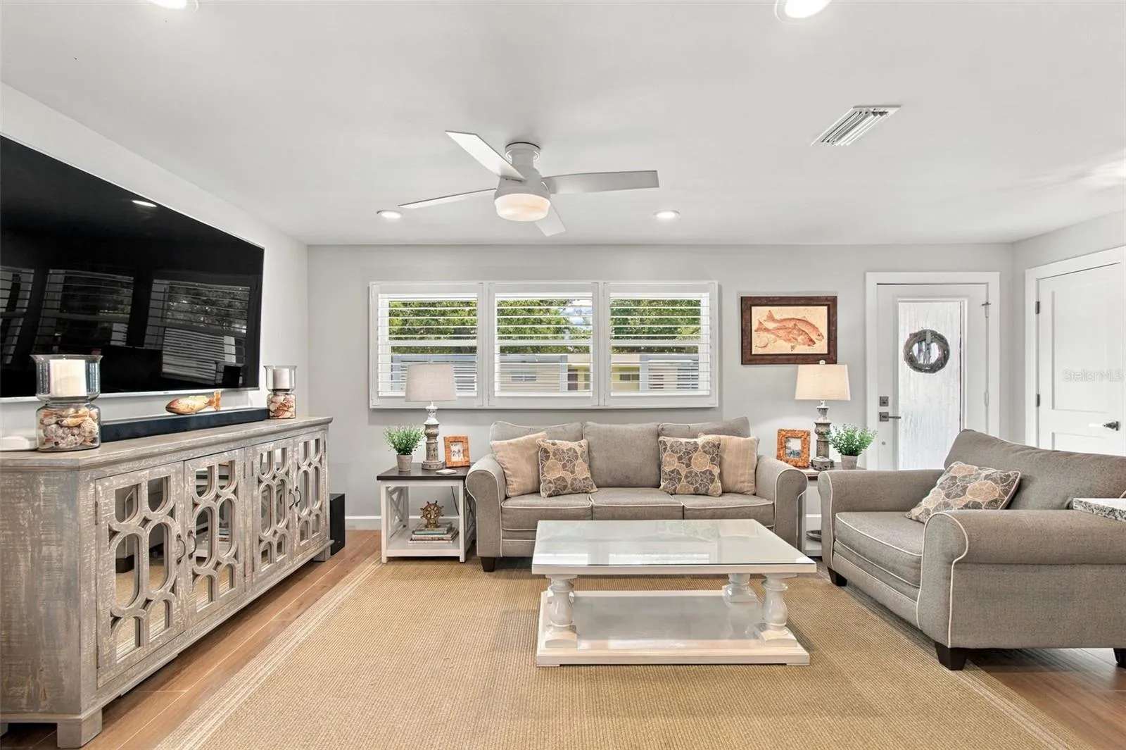 Hurricane Impact Windows with custom wood shutters throughout this gorgeous home!