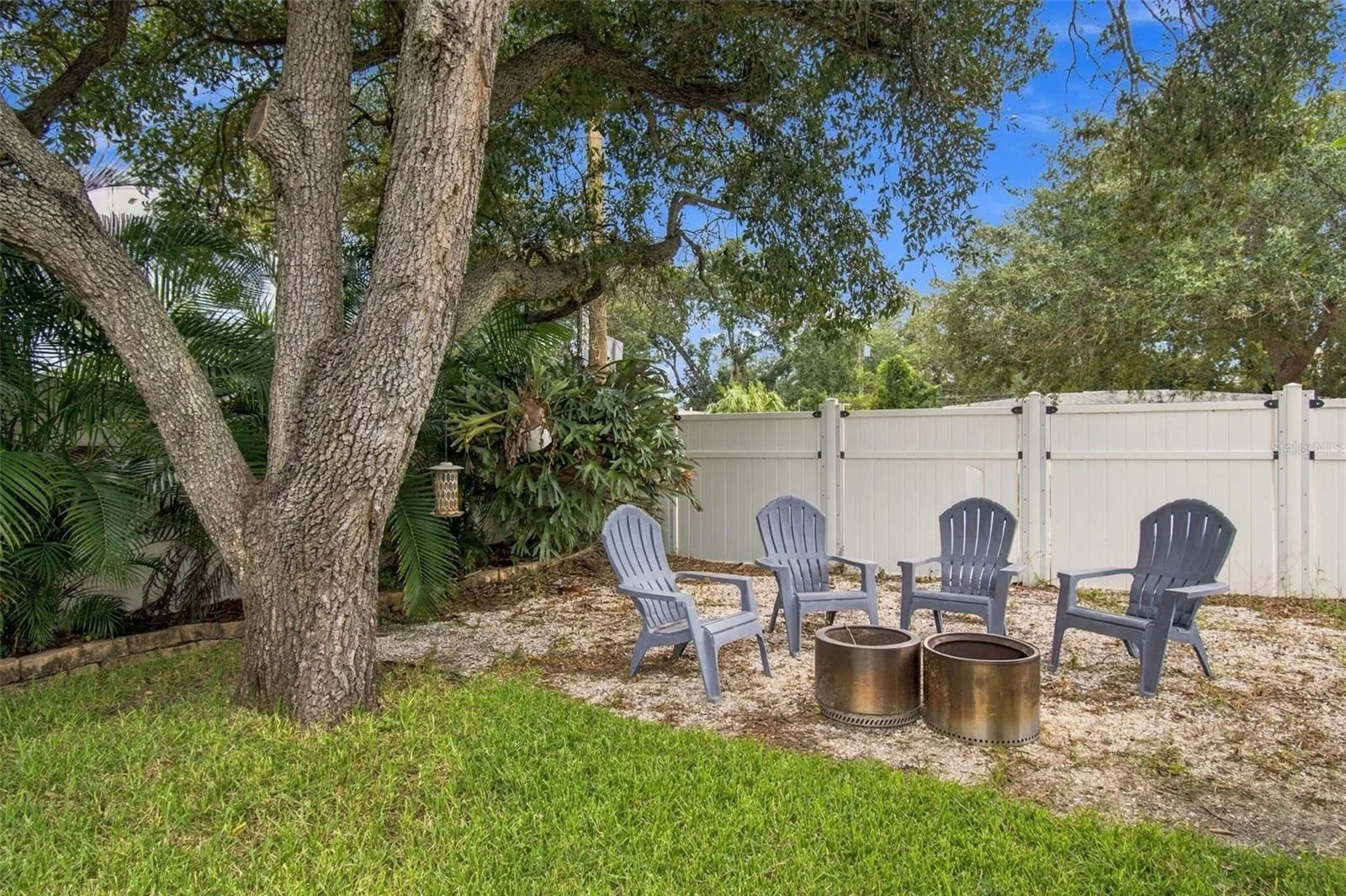 Your fully fenced yard is complete with beautiful trees and firepit area.