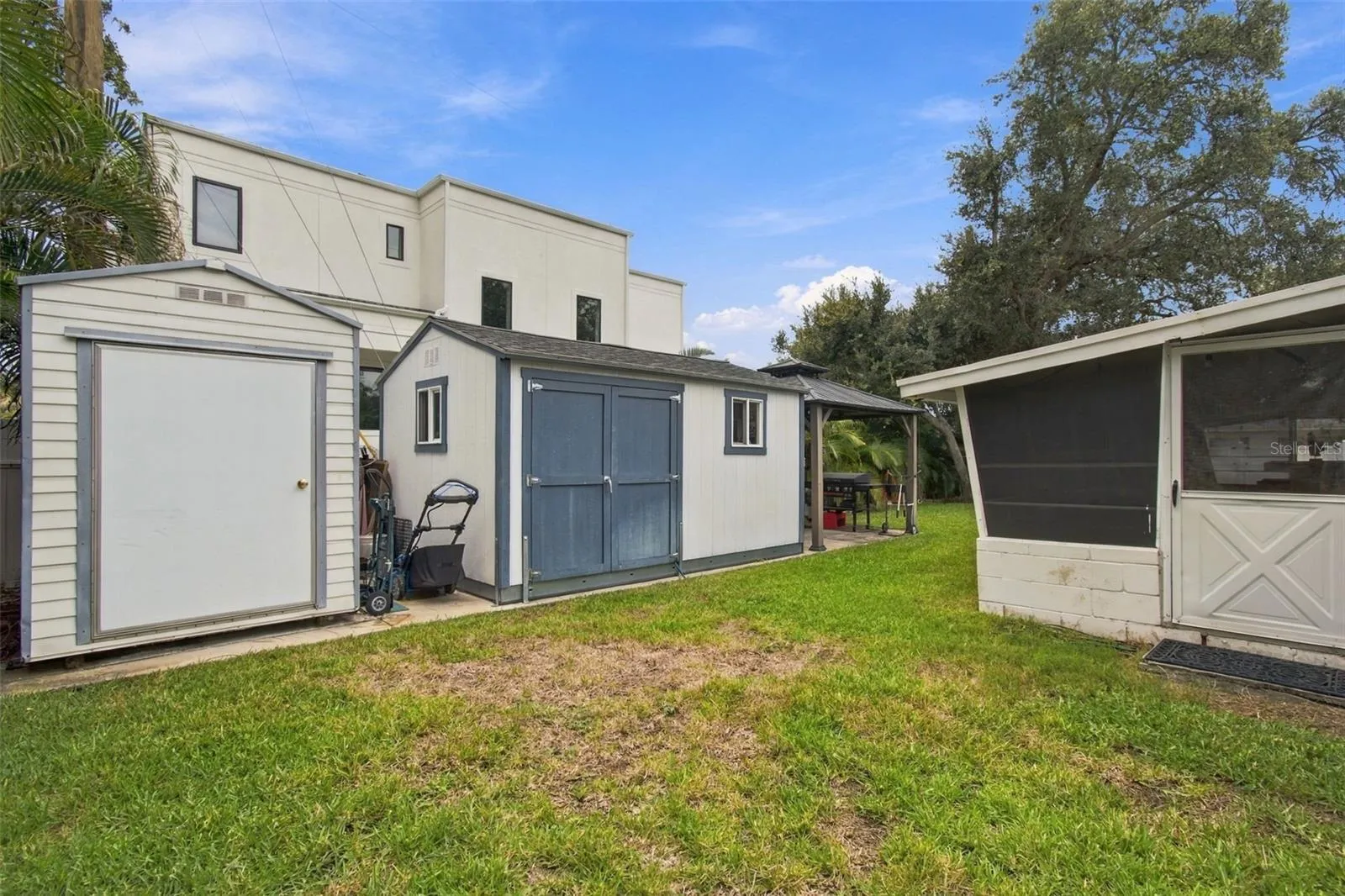 Plenty of extra storage out back plus workshoop and covered BBQ area