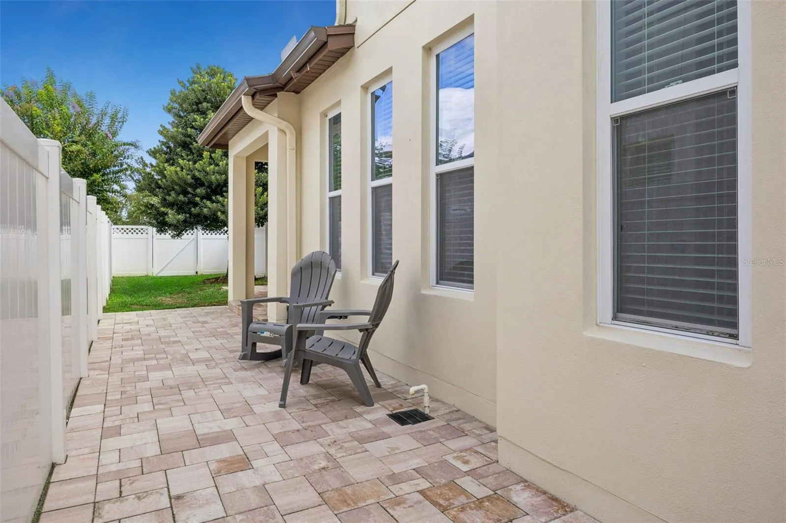 Covered patio with new pavers, and fully fenced in yard