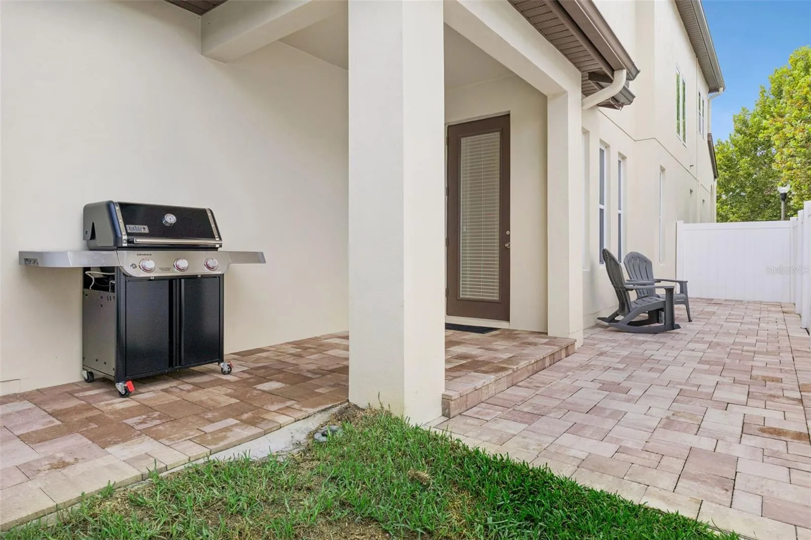 Covered patio with new pavers, and fully fenced in yard