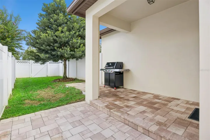 Covered patio with new pavers, and fully fenced in yard