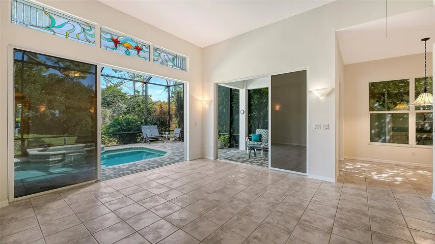 Living room opens to pool and spa and to covered lanai and breakfast room.