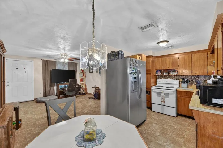 Spacious open floor plan, looking towards living room from laundry/storage room.