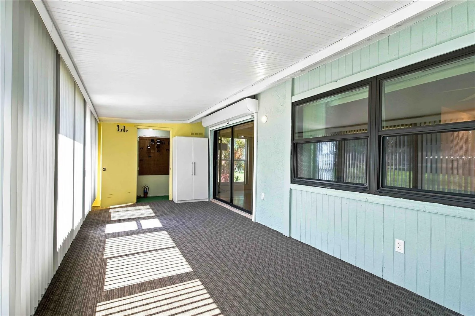 HUGE LANAI WITH HURRICANE WINDOWS, SHUTTERS, NEW BLINDS, INSULATED ROOF, STORAGE, MINI SPLIT AC, AND ELECTRICAL HOOKUPS.