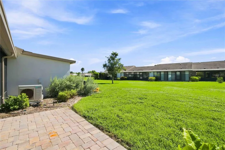 BACK PATIO AND GRASSY FIELD