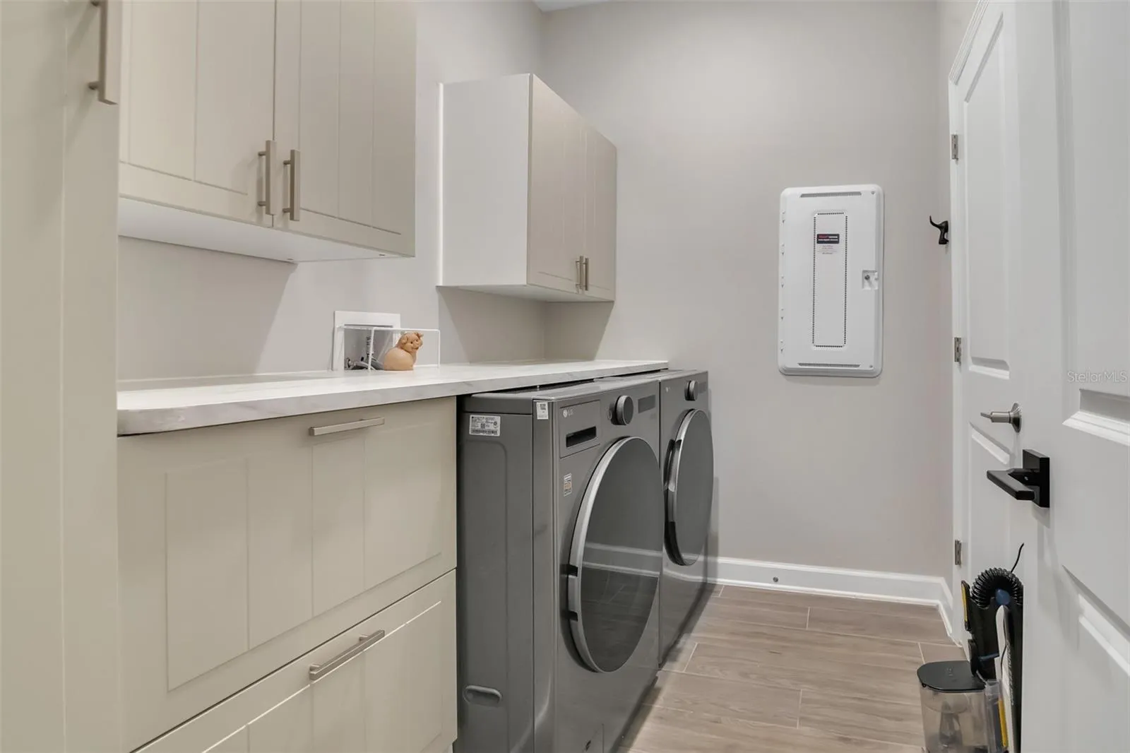 Laundry room with custom cabinetry - smart washer and dryer included