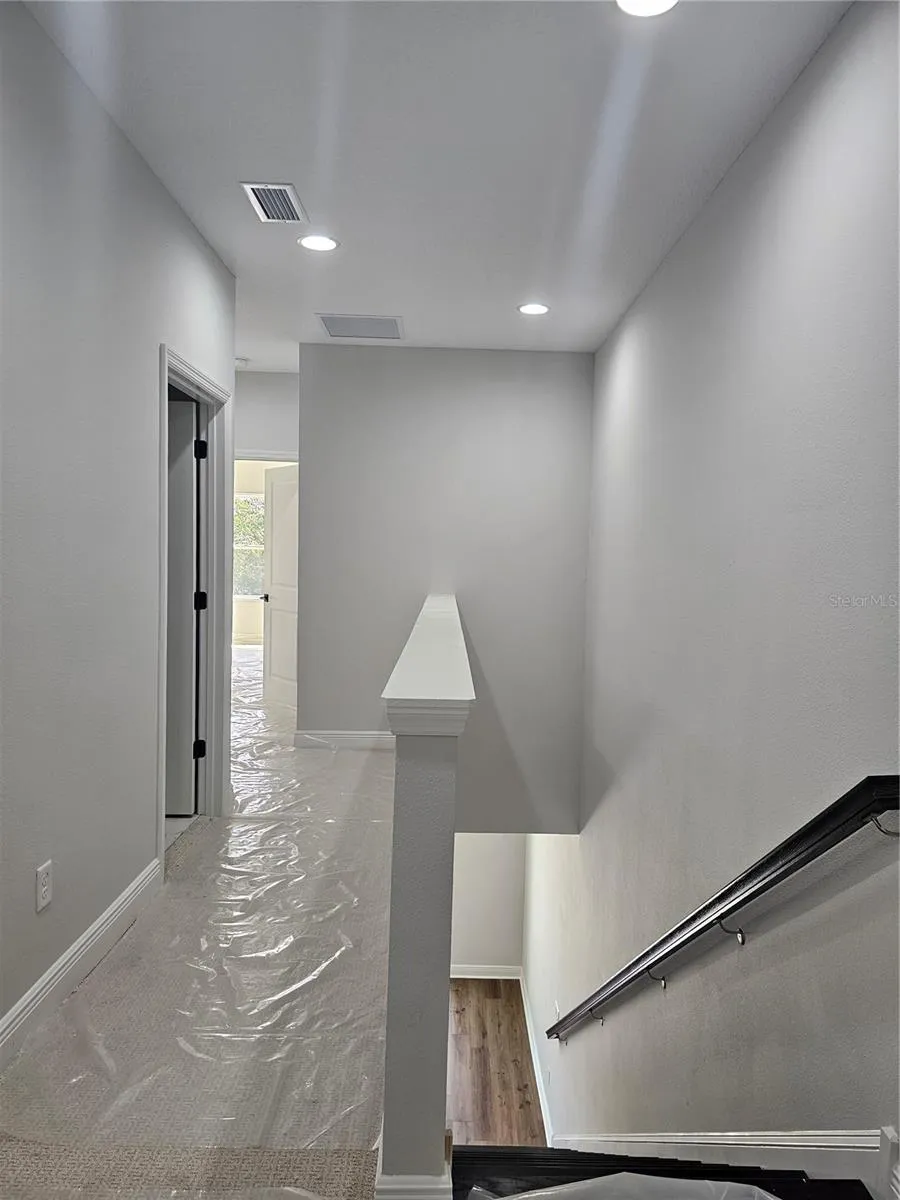 hall toward primary bedroom and laundry room