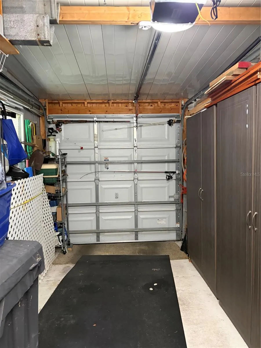 Garage with work bench and cabinets