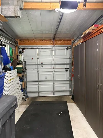 Garage with work bench and cabinets