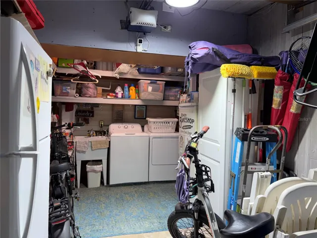 Garage with laundry area and storage room