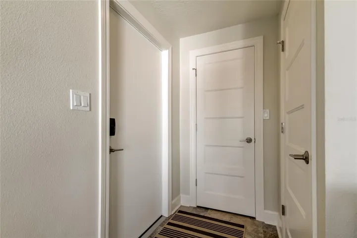 Front door on the left, Two closets for storage and entrance to the attic.
