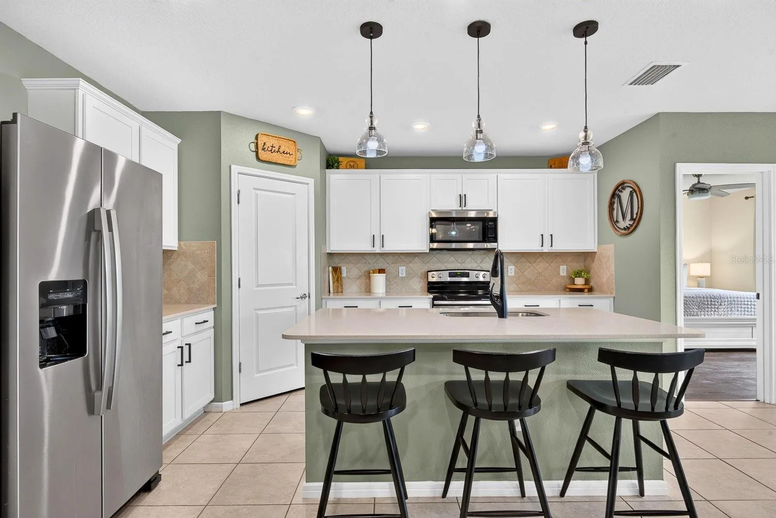 Facing into kitchen showing Master bedroom in the back of home