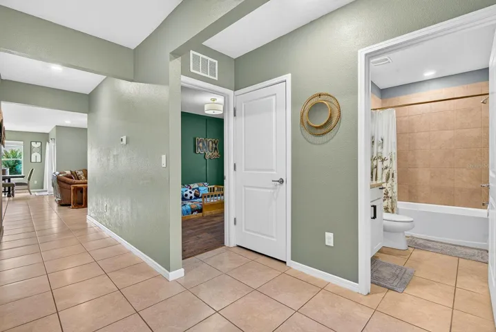 Large hallway showing entrance to bedroom and guest bath