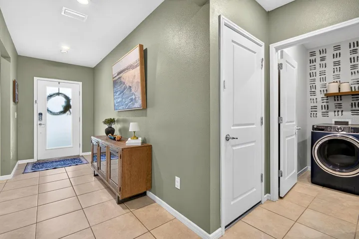 Hallway facing front showing laundry area to the right