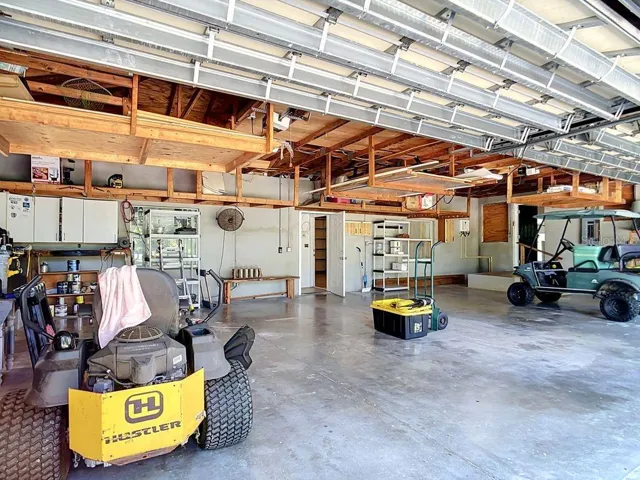 Spacious 4 Car Garage with 1 of 2 entrances to the Separate Living Quarters/Mother In Law Suite.