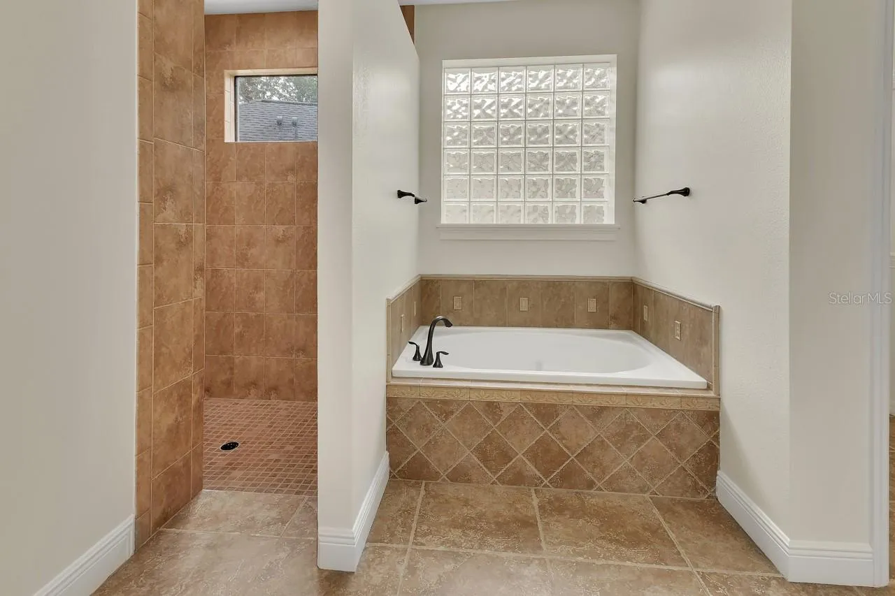 Primary bathroom with huge garden tub and walk in shower