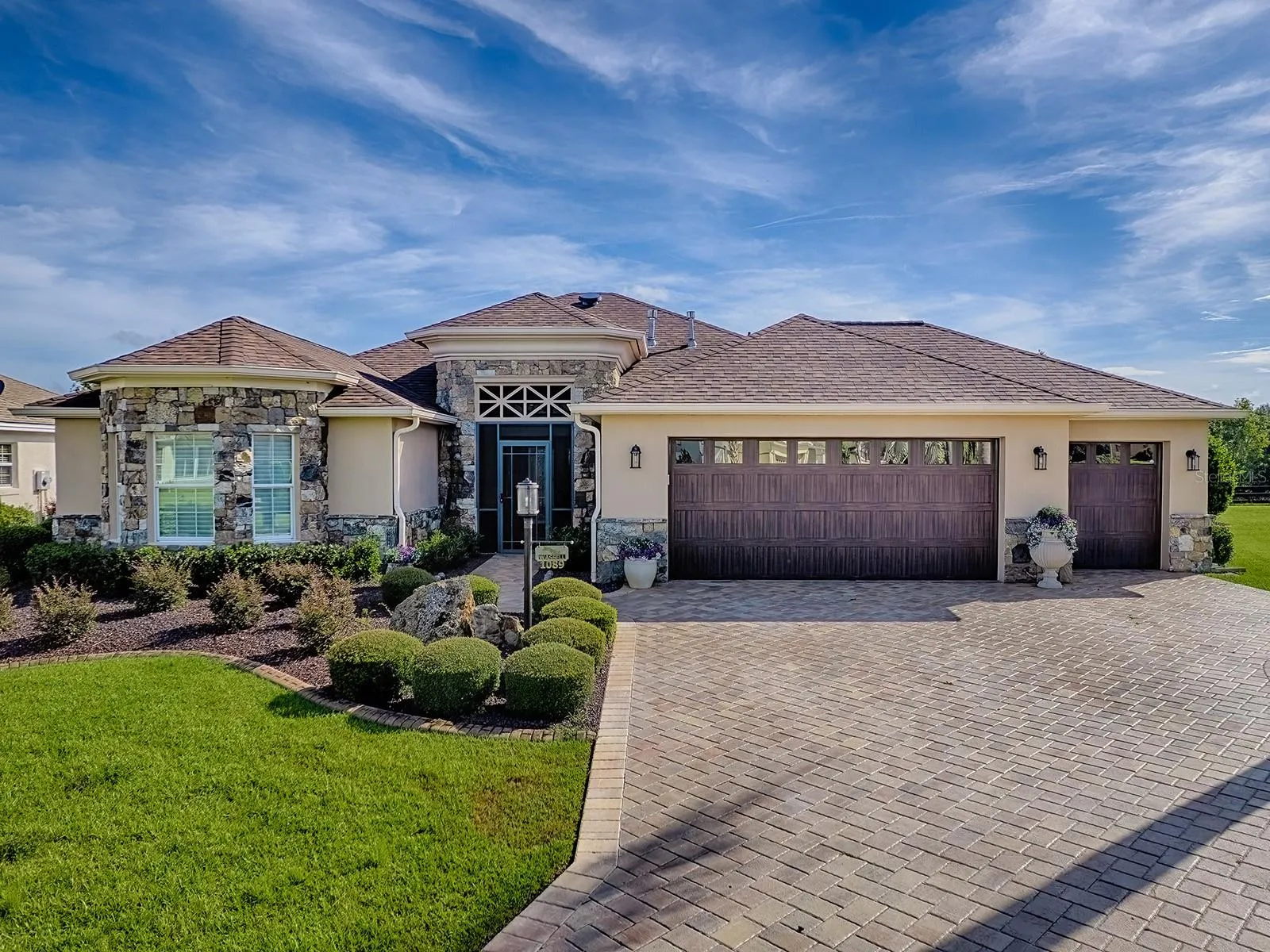 STUNNING LANDSCAPING AND UNIQUE EXTERIOR STONE AND STUCCO WORK