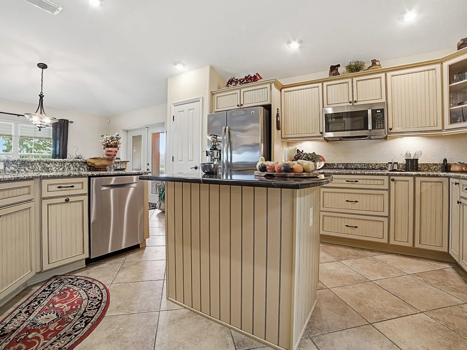 AN ISLAND FOR ADDED COUNTER SPACE AND WORK AREA
