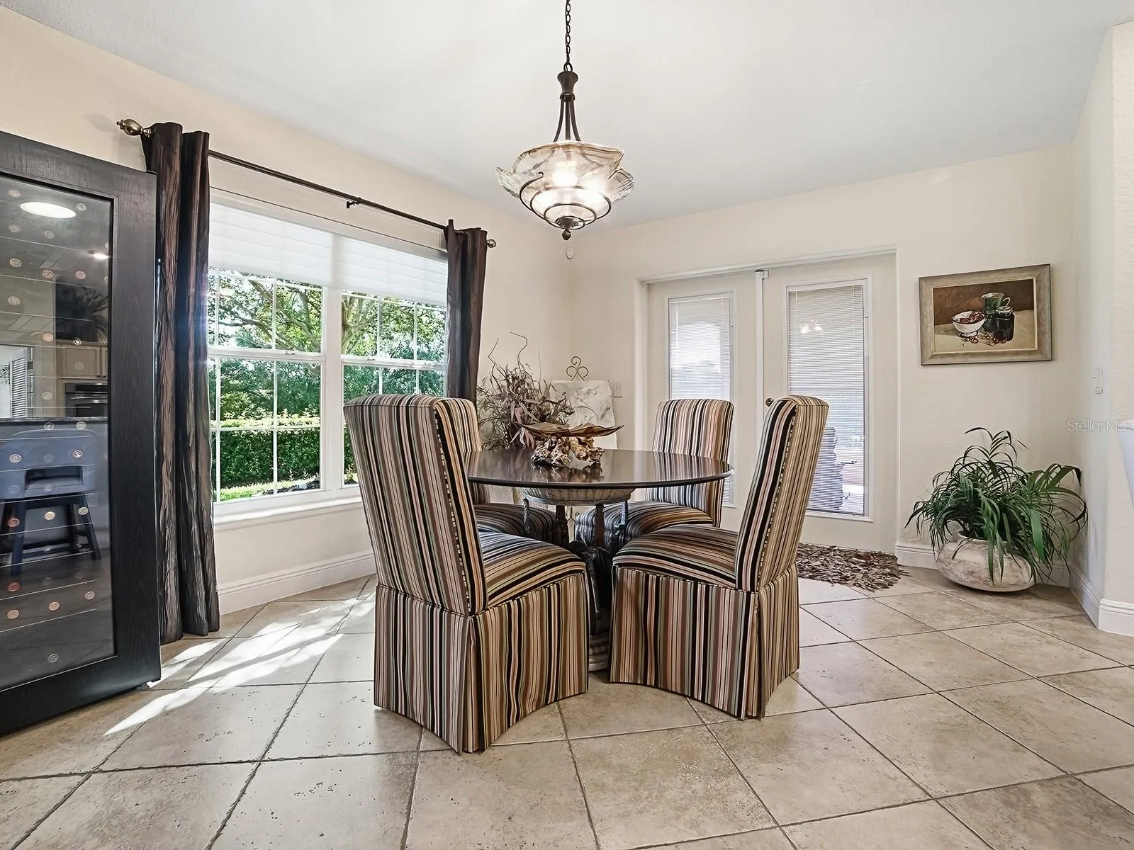 EAT IN KITCHEN WITH NATURAL SUNLIGHT POURING IN AND DOORS TO THE SIDE LANAI