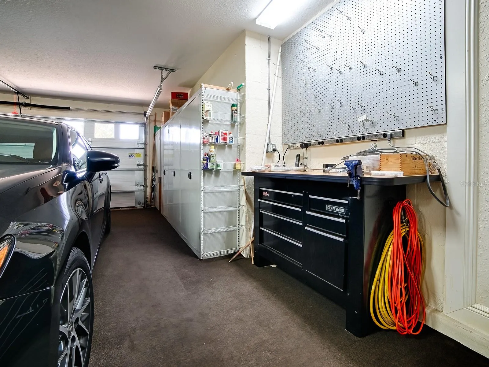 LOTS A CABINET SPACE AND INSULATED GARAGE DOORS FOR A COMFORTABLE WORK SPACE